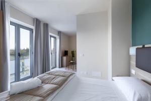 Postel nebo postele na pokoji v ubytování Tuscasì Aparthotel