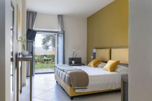 Postel nebo postele na pokoji v ubytování Tuscasì Aparthotel