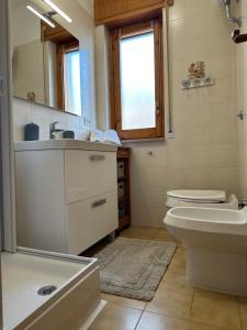 a bathroom with a sink toilet and a mirror at CASA SOFIA in Scalea +24 photos