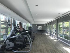 a woman exercising on treadmills in a gym at Baan Thewlom in Cha Am