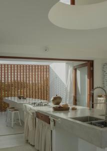 a kitchen with a sink and a counter top at Casa Attico - Design Beach House in Touros