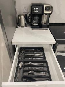 a kitchen with a coffee maker on top of a refrigerator at luxury & Spacious 2 bedrooms basement serviced apartment in Brampton