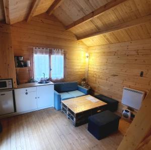 un salon avec un canapé bleu et une table dans l'établissement Les Chalets de Parly, à Parly