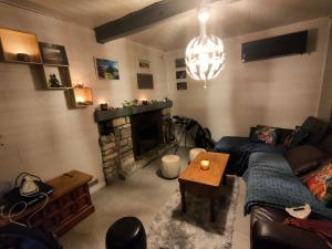 - un salon avec un canapé et une cheminée dans l'établissement Maison de ski et randonnée, 
