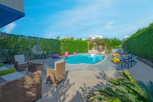 a backyard with a swimming pool and a fence at Spacious villa with private pool in Hurghada