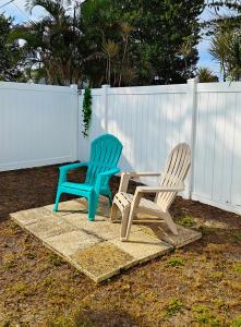two chairs and a table in front of a fence at Lovely unit central location in St Petersburg