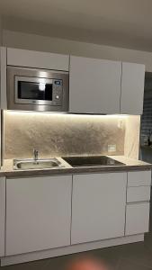 a kitchen with a sink and a microwave at PALAZZOREFICI in Naples