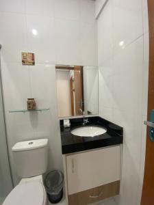 a small bathroom with a toilet and a sink at Refugio Urbano in Goiânia