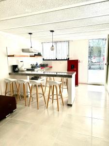 a kitchen with a table and chairs in a room at Depa Lunero in Cancún