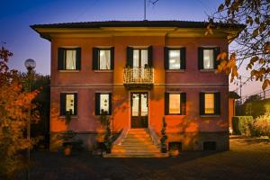 an orange house with stairs in front of it at Villa Trevisi - ROOMS in Treviso