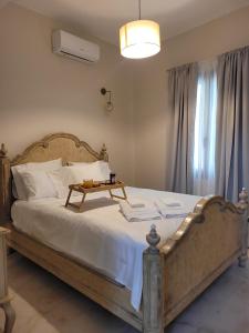 a bedroom with a bed with a table on it at City Center Suites in Karpathos