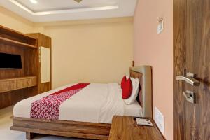 a bedroom with a bed and a table in it at Bhagirathi Residency in Anantapur