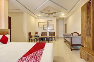 a bedroom with a bed and a dining room at Bhagirathi Residency in Anantapur