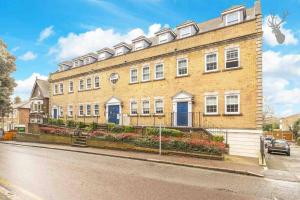 a large brick building on the side of a street at Elegant Central Brentwood Flat in Brentwood