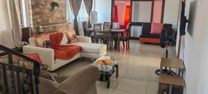 a living room with two couches and a table at ocean palace self catering lodge in Durban