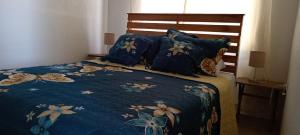 Bett mit blauer Bettdecke und Kissen in der Unterkunft Casa Finca Lindora in Monteverde Costa Rica
