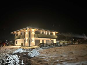 a building with lights on the side of it at night at Alpin Apartments in Radstadt