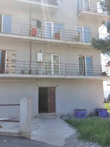 a white building with a door and a balcony at Wonderful_place_for 2 persons in Tbilisi City