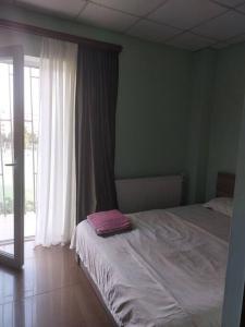 a bedroom with a bed and a large window at Wonderful_place_for 2 persons in Tbilisi City