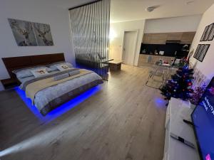 a bedroom with a bed and a christmas tree at O2 Arena - Alex Apartment Praha in Prague