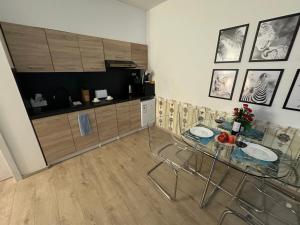 a kitchen with a glass table in a room at O2 Arena - Alex Apartment Praha in Prague