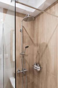 a shower with a glass door in a bathroom at Virginia's Luxury Suite 4 in Volos