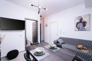 a living room with a table and a couch at Stella Apartment in Kali Limenes