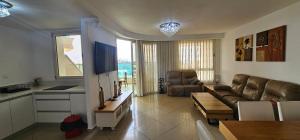 a living room with a couch and a table at De Golf Luxury Resort Apartments in Eilat