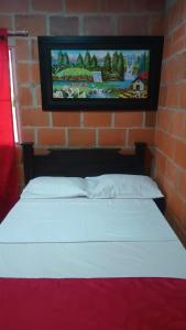 a bed in a room with a brick wall at Hotel campestre la isla in Neiva