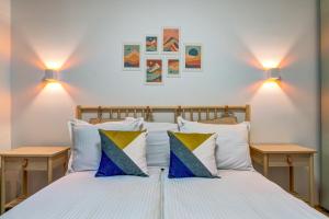 a bedroom with a bed with blue and white pillows at N.Joy Holiday Apartment 534 by Oak Residence in Smolyan +22 photos