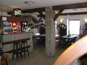 a bar in a restaurant with tables and chairs at Studánecký Medvěd in Liberec +30 photos