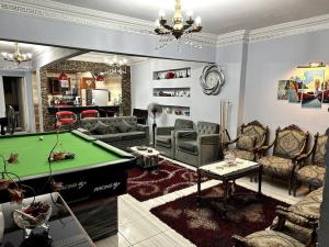 a living room with a pool table in it at Sanctuary in Cairo