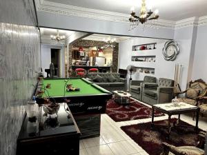 a living room with a pool table in it at Sanctuary in Cairo