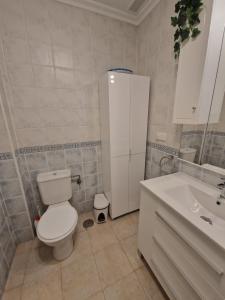 a bathroom with a white toilet and a sink at The Hideaway 2 Bed Poolside Groundfloor Apartment On Albatros Full AC Free Fast Wifi in Los Alcázares +19 photos