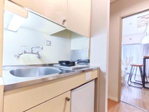 a kitchen with a sink and a stove at S31 Shibuya center 7 mins to Station, Max 4P涉谷最中心 涉谷站7分-S 直达表参道 池袋 上野 代代木 银座 原宿 in Tokyo