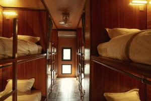 a room with three bunk beds on a train at House Of Jars in Vientiane