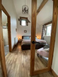 a room with two beds and a door to a bedroom at Unique Stay on an Alpaca Therapy Farm with Miniature Donkeys North Wales in Mold