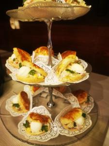 a plate of mini sandwiches on a glass tower at Hotel Cis in Świnoujście