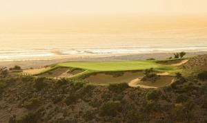 an aerial view of a golf course at the ocean at Santorini Taghazout - T2 luxe-piscine - 3 or 4 Px in Tamraght Ouzdar