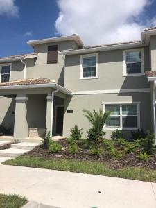 a large white house with at Makin Memories Gated Resort Style Community Storey Lake in Kissimmee