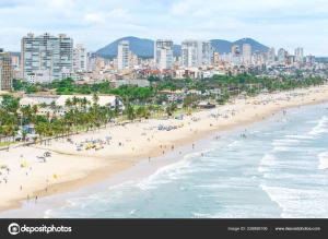 an aerial view of a beach with people and buildings at Casa, Piscina, Sinuca Churrasqueira, Ping Pong, Praia Guarujá in Guarujá