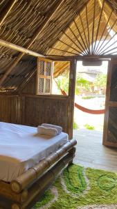 a bedroom with a bed in a hut at Guajira Beach in Ríohacha