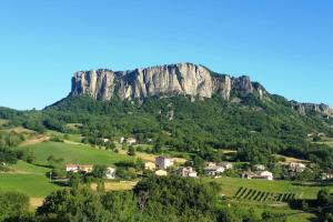 a village in front of a large mountain at Pietra di Bismantova Short Lets in Castelnovo neʼ Monti
