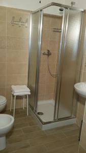 a bathroom with a shower and a toilet and a sink at Pietra di Bismantova Short Lets in Castelnovo neʼ Monti