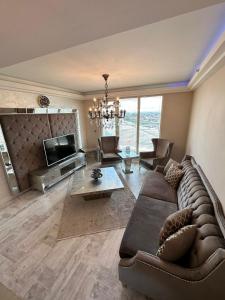 a living room with a couch and a tv at Luxury apartment in Skopje in Skopje