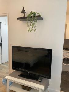 a flat screen tv sitting on top of a white wall at Luxsuite in Aubervilliers