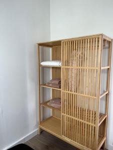 a wooden book shelf with towels and a frisbee at LAZURITE MASPALOMAS Apartamentos Sur Gran Canaria in El Tablero