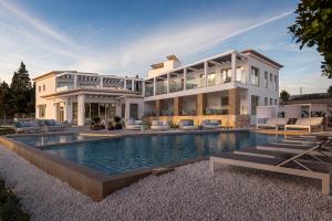 a large white house with a swimming pool at Dionis Boutique Hotel & Spa in Jávea