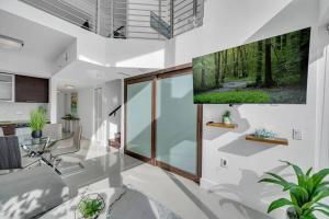 a living room with a large wall mural of a forest at Luxury 2 Bedroom Loft Brickell-WaterViews in Miami