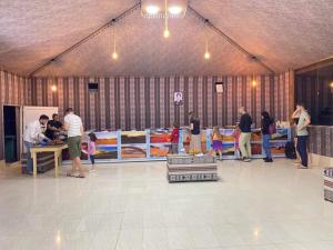 a group of people standing in a large room at Miral Night Camp in Wadi Rum